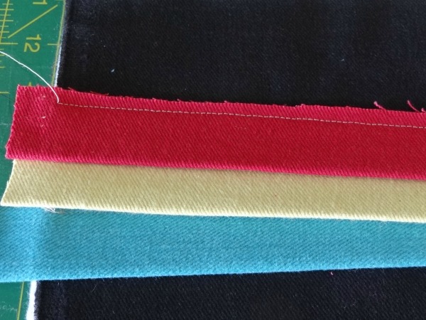 folded strips on denim clutch – Copy