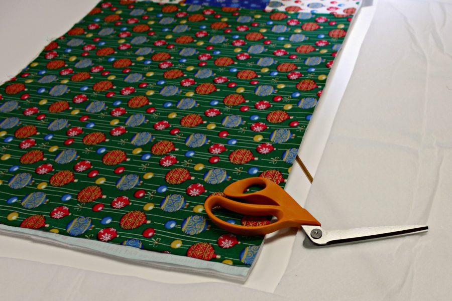 cutting fusible fleece for Christmas table runner by Carla at Creatin in the sticks for Thermoweb