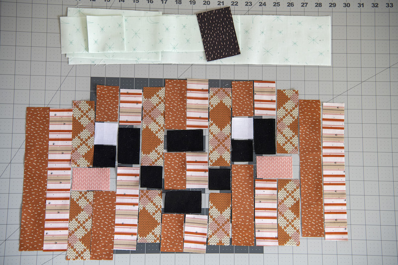 happy pumpkin quilt block pieces arranged together
