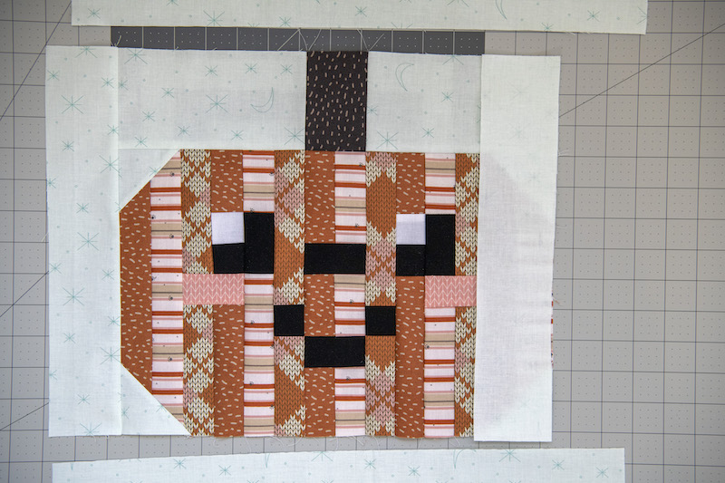 attach the side pieces to the pumpkin quilt block