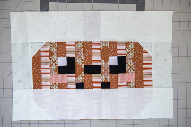 sew on the bottom piece to the quilt block