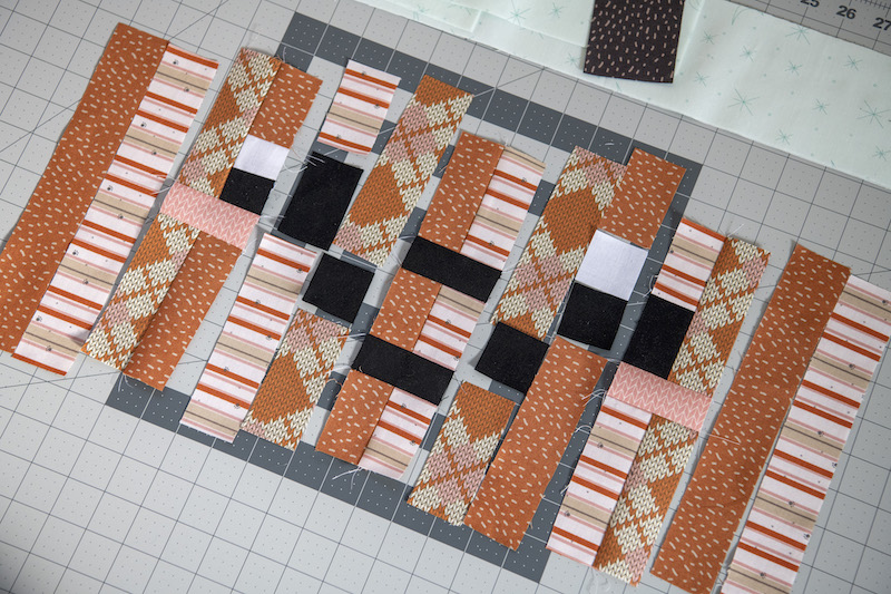 laying out all the cut pieces of the pumpkin quilt block