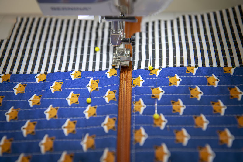 top stitch the edges at the zipper