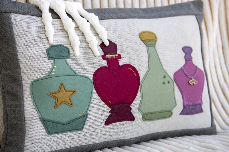 pillow with potion bottle applique